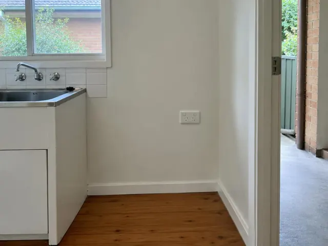 White double power point on a kitchen wall beside a sink and timber floor in Cromer